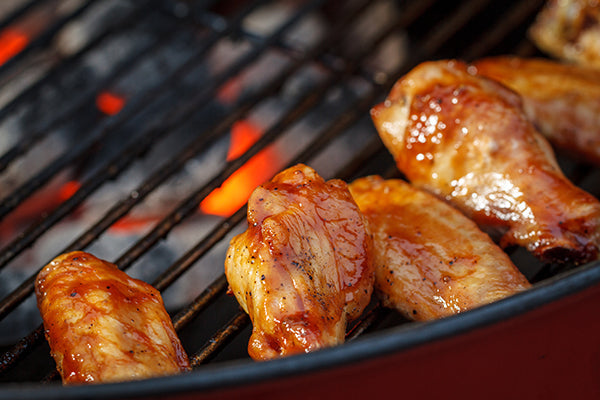 Grilled chicken wings on a weber red kettle charcoal grill – Tailgating 101 – Weber Grills