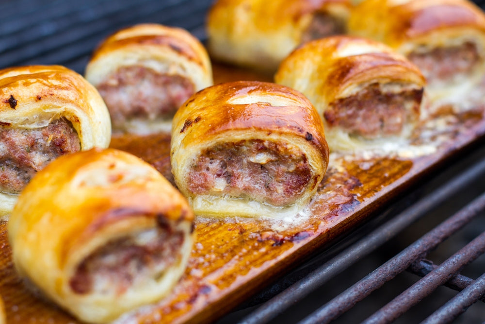 56817B7694590 2015 12 Week 5 Nye Lang Planked Sausage Rolls Photo Planked Sausage Rolls On Charcoal Copy