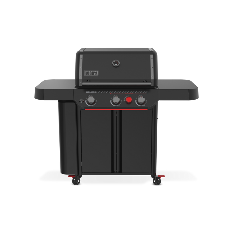 Front view of the matte black Weber Genesis E-330 Gas Grill Stealth Edition with the lid closed, a built-in thermometer, two side tables, enclosed storage, and a red Sear Burner knob.