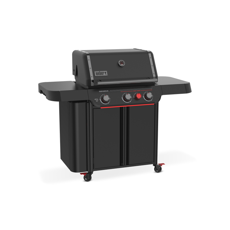 Front-left view of the matte black Weber Genesis E-330 Gas Grill Stealth Edition with the lid closed, two side tables, tool hooks, enclosed storage, and a red Sear Burner knob.