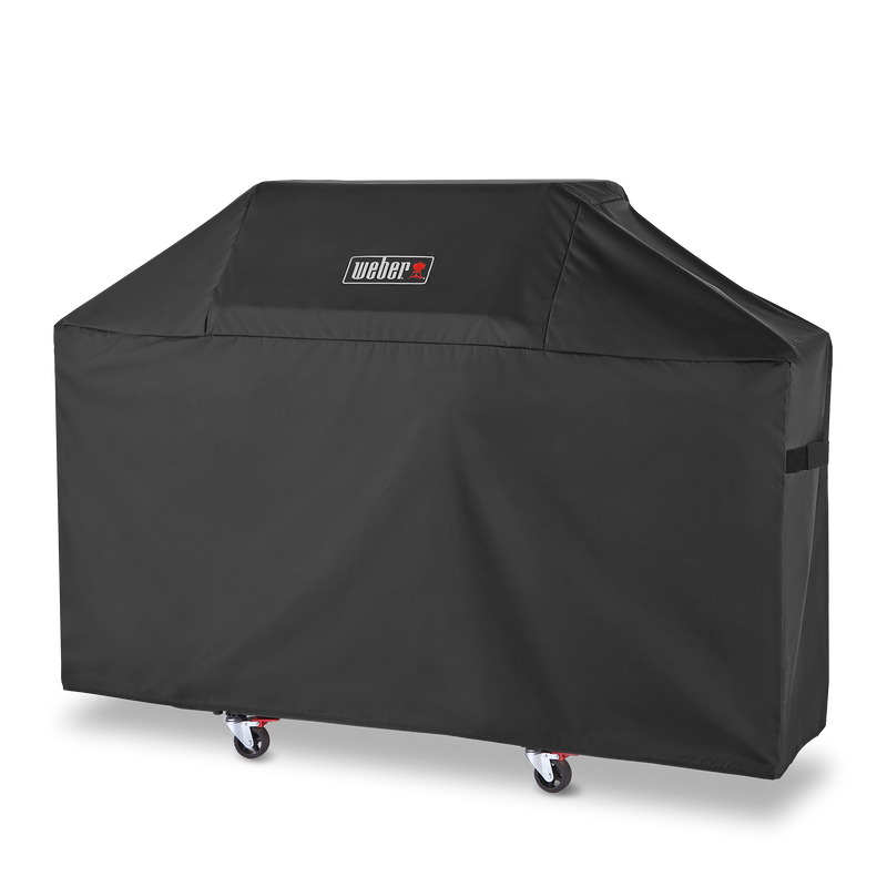 Side fastening straps keep the Weber Premium Grill Cover secure over a Genesis 3-burner gas grill between uses.