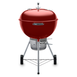 Red Weber 22” Original Kettle Premium charcoal grill with adjustable dampers for heat control and an enclosed ash catcher for cleanup.