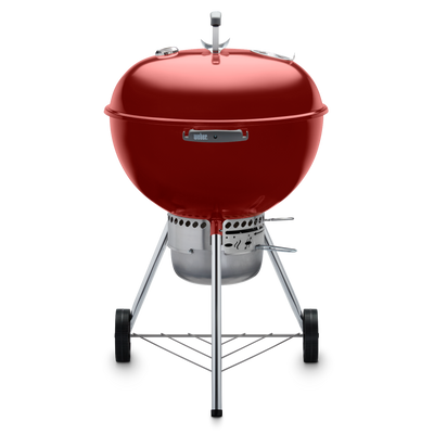 Red Weber 22” Original Kettle Premium charcoal grill with adjustable dampers for heat control and an enclosed ash catcher for cleanup.