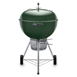 Green Weber 22” Original Kettle Premium charcoal grill with adjustable dampers for heat control and an enclosed ash catcher for cleanup.