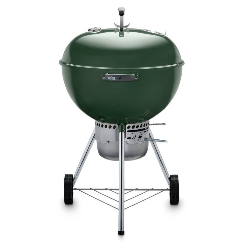 Green Weber 22” Original Kettle Premium charcoal grill with adjustable dampers for heat control and an enclosed ash catcher for cleanup.