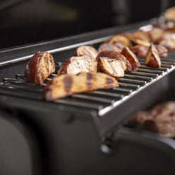 The warming rack keeps food warm or toasts sides while the main course grills below.