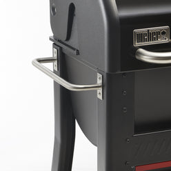Sturdy side handle provides an easy grip for moving the grill.