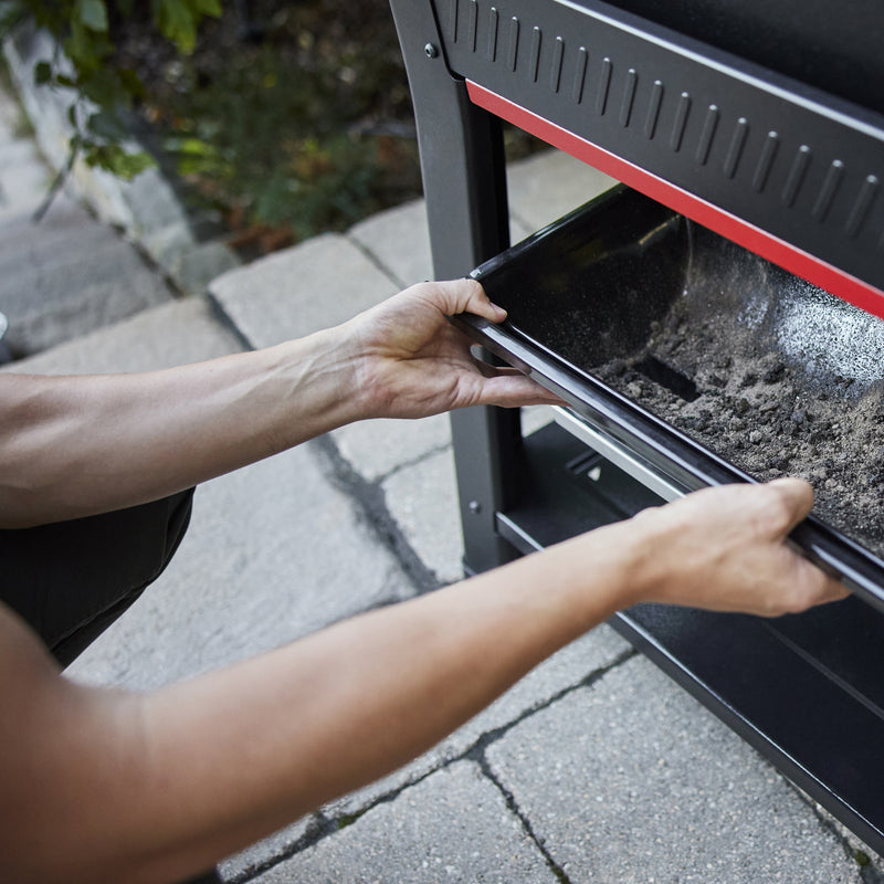 Removable ash and grease tray on the Weber Searwood 600 wood pellet grill makes cleanup easy.