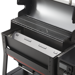 Interior of the Weber Searwood XL 600 wood pellet grill showing the upper cooking grate and heat distribution system.