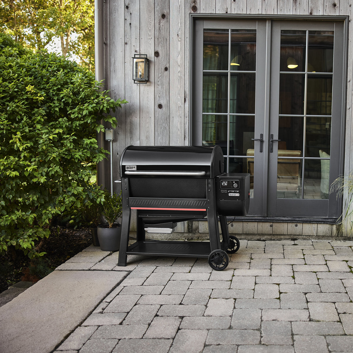 Weber Searwood XL 600 wood pellet grill featured on an outdoor patio.