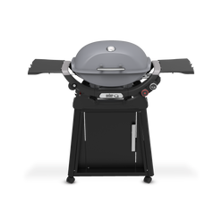 Smoke Gray Gas Grill on a wheeled cart with a closed domed lid, built-in thermometer, extended side tables, two burner control knobs, and a cabinet door.