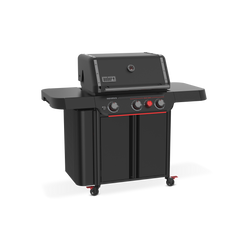 Front-left view of the matte black Weber Genesis E-330 Gas Grill Stealth Edition with the lid closed, two side tables, tool hooks, enclosed storage, and a red Sear Burner knob.