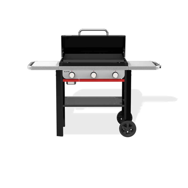 Weber Slate 28" Rust-Resistant Griddle with an open hard cover exposing the flat cooktop, two side tables, three front control knobs, a lower storage shelf, and two wheels.