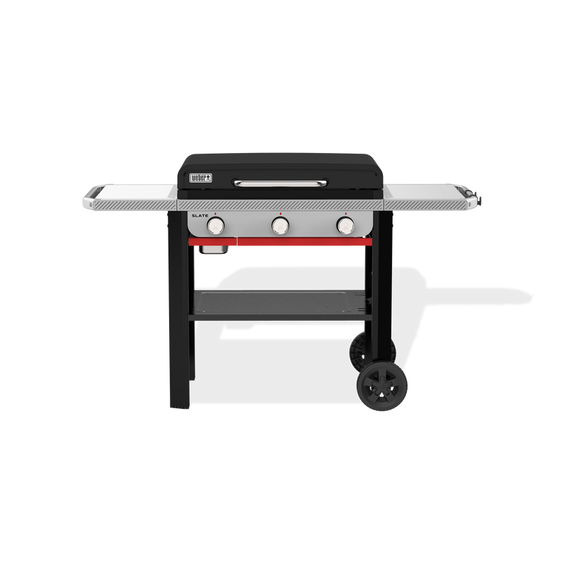 Weber Slate 28" Rust-Resistant Griddle with a closed hard cover, two side tables, three front control knobs, a lower storage shelf, and two wheels.