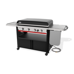 Front-right view of the Weber Slate 36” Rust-Resistant Griddle with the hard cover closed, four control knobs, a digital thermometer, lower storage cabinets and the flip-up side table folded down.