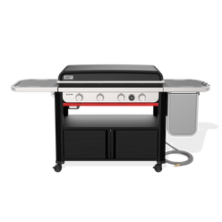 Front view of the Weber Slate 36” Rust-Resistant Griddle with the hard cover closed, four control knobs, a digital thermometer, side tables and lower storage cabinets.