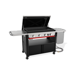 Front-left view of the Weber Slate 36” Rust-Resistant Griddle with the hard cover open, a pre-seasoned carbon-steel plate, four control knobs, a digital thermometer and the flip-up side table folded down.