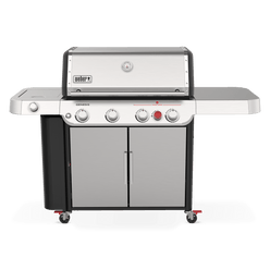A stainless-steel lid with a built-in thermometer tops the Weber Genesis S-435 Gas Grill, with a covered side burner, red sear burner control, large side table, and double-door cabinet.