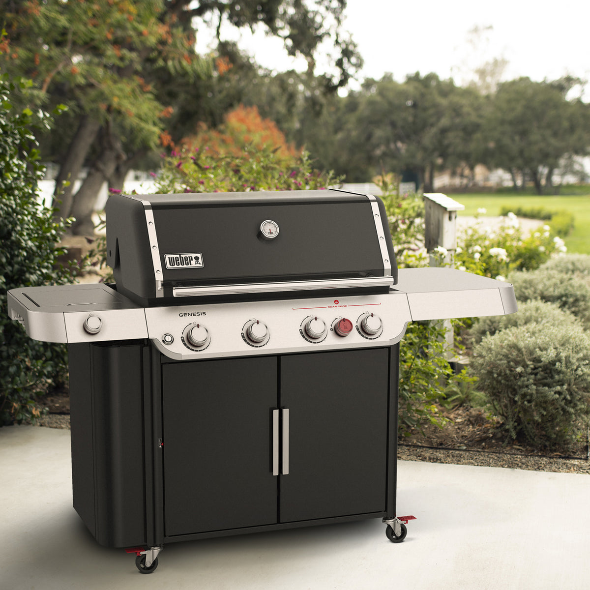 Weber Genesis E-435 gas grill ready for backyard cooking with an extra-large prep and serve table and enclosed storage.