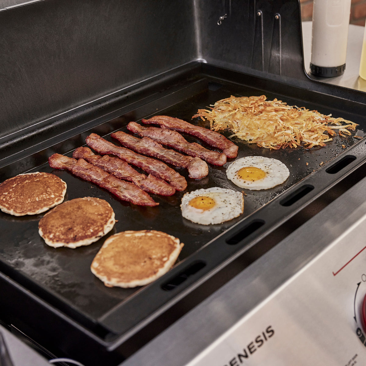Weber Rust-Resistant Griddle Insert cooks pancakes, bacon, eggs, and hash browns together for a full outdoor breakfast.