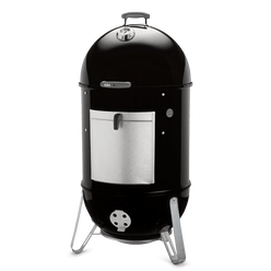 Angled view of the black Weber 22" Smokey Mountain Cooker Smoker with a lid thermometer, aluminum fuel door, silicone temperature grommet, and three metal legs.