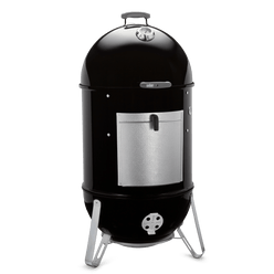 Angled view of the black Weber 22" Smokey Mountain Cooker Smoker with a domed lid, built-in thermometer, removable aluminum fuel door, and adjustable lower damper.