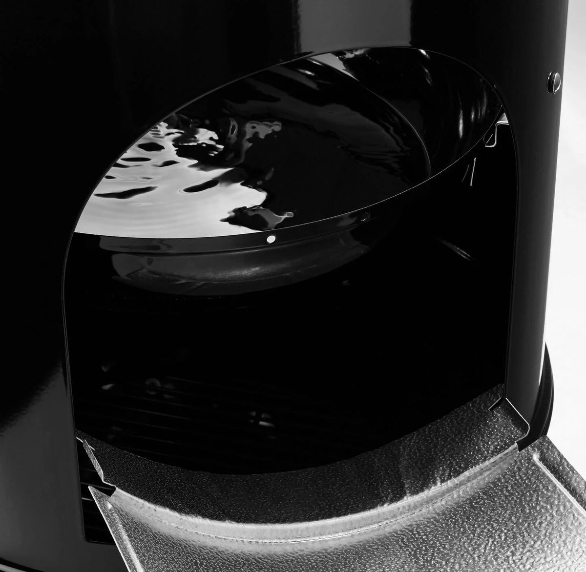 The water pan helps regulate temperature inside of the smoker and adds moisture to the heat. 