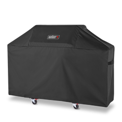 Side fastening straps keep the Weber Premium Grill Cover secure over a Genesis 3-burner gas grill between uses.