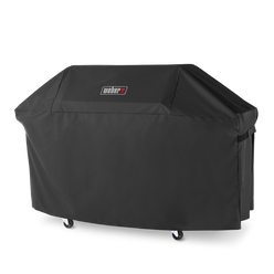 A side fastening strap secures the black Weber Premium Grill Cover around a Genesis grill, with the Weber logo on the front and casters visible below.