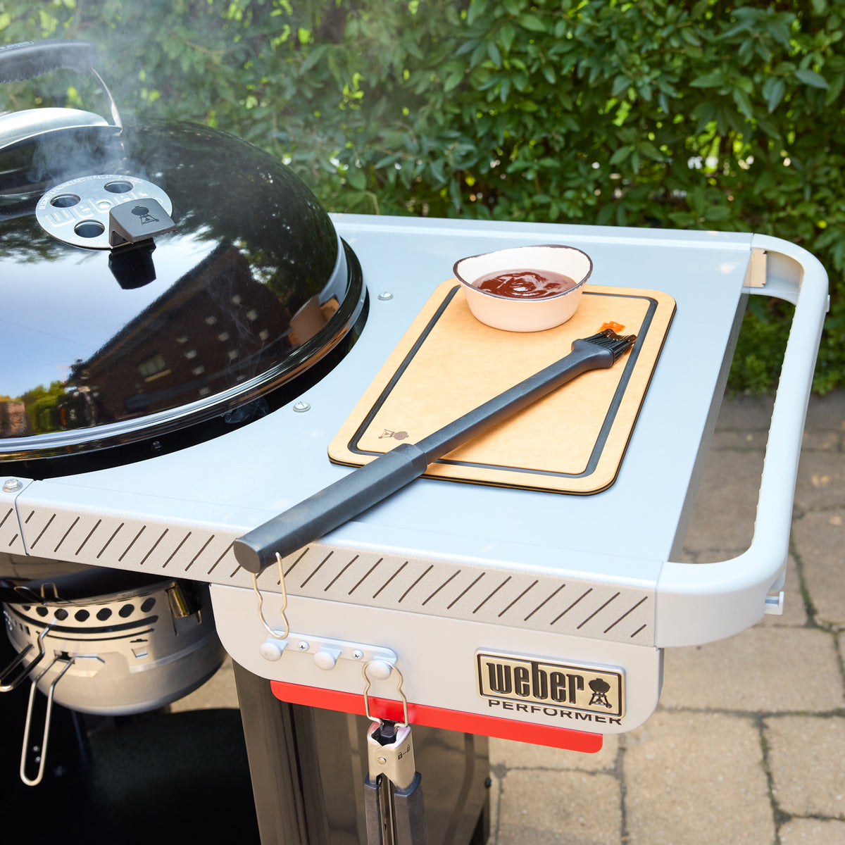 The work table provides convenient space for prepping food, and keeping sauces and grilling tools ready.