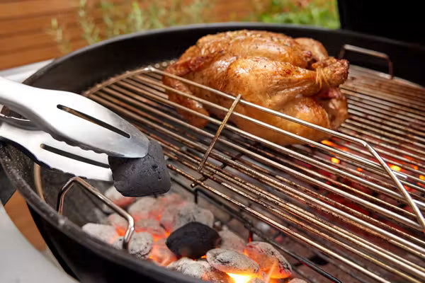 Hinged cooking grate flips up on both sides so you can add charcoal while grilling without removing grate. 