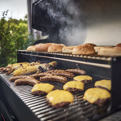 Cook burgers and sides on the main cooking surface and toast buns on the warming rack. 