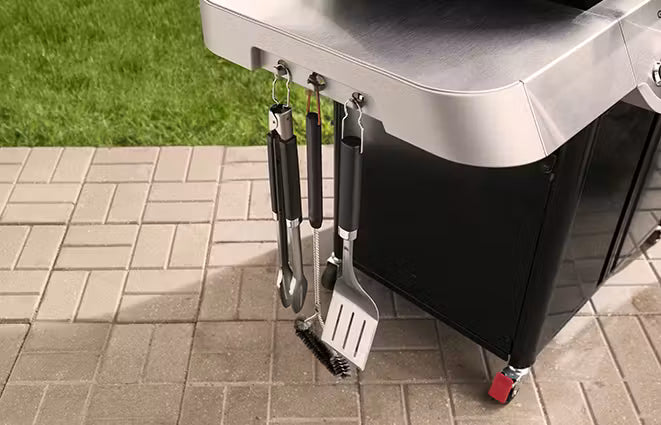 Side tables keep platters, seasonings, and tools within arm’s reach, while providing extra space for prepping.