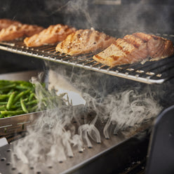 Stainless-steel smoker box adds wood-smoked flavor to salmon, veggies, and more. 
